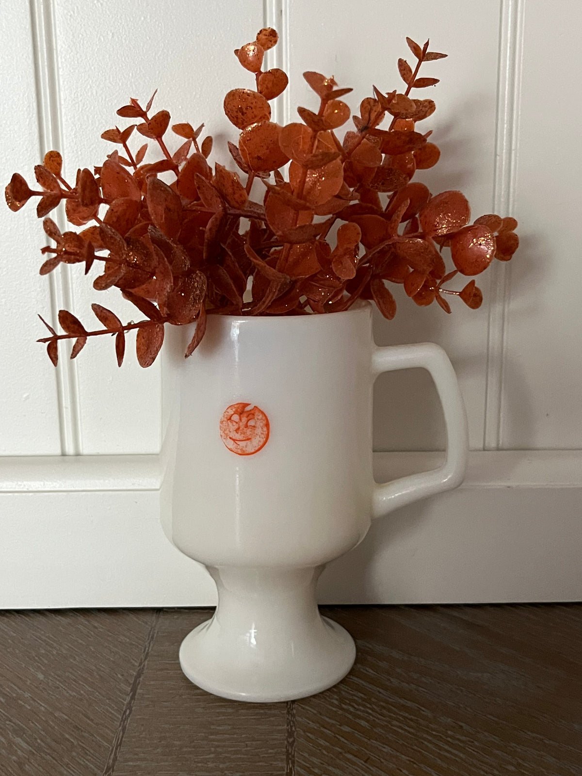 White Pedestal Mug with Orange Moon Face | Curated Shelf & Trinket Display Décor