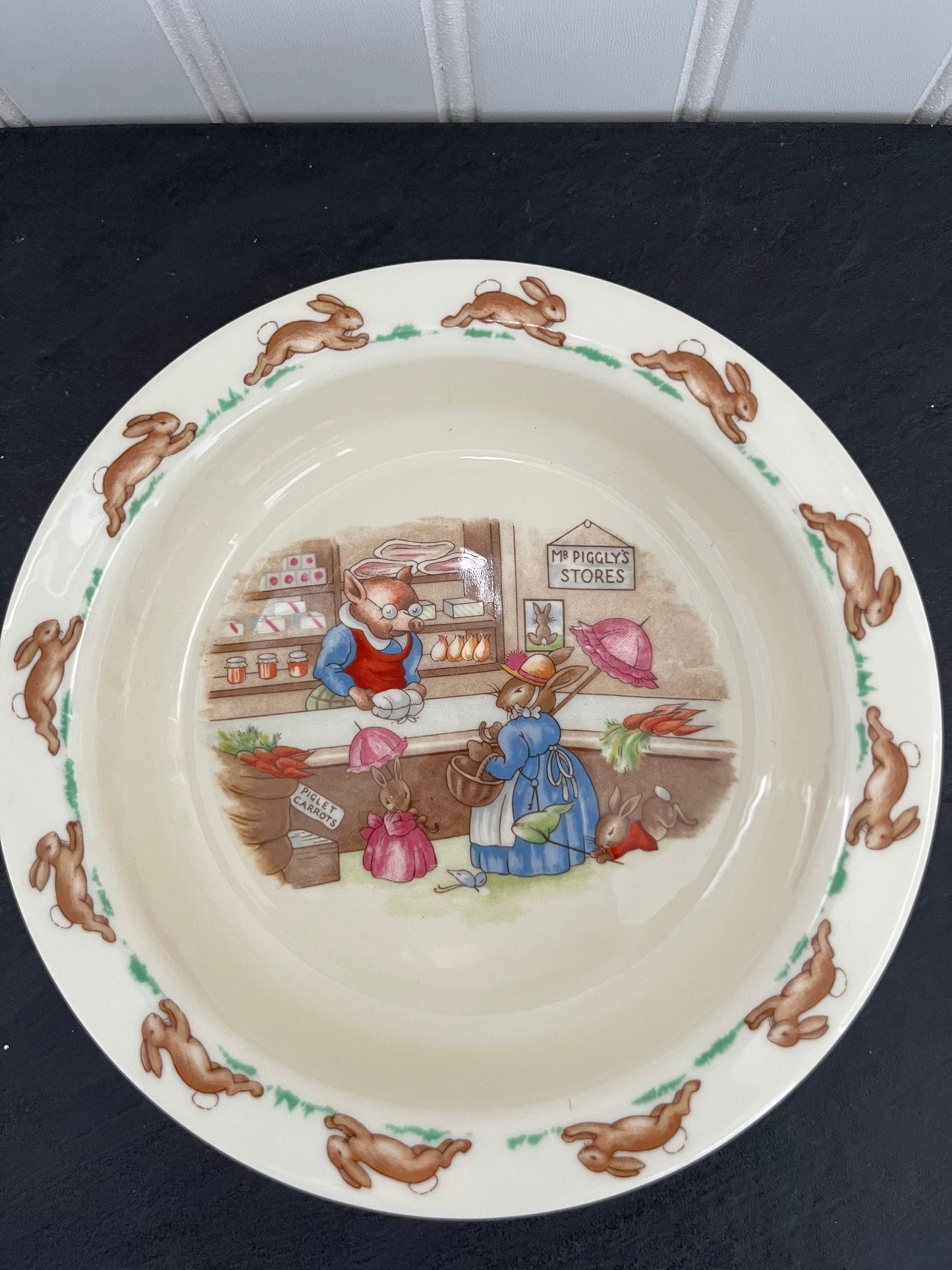 1984 Royal Doulton Bunnykins Porridge Bowl – Golden Jubilee – “Mr. Piggly’s Store” Scene (6.5”)