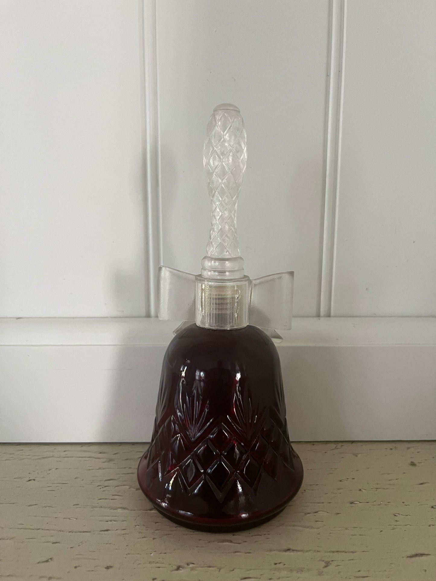 1970s vintage Avon Crystalsong Sonnet cologne Empty Ruby Red bottle in a bell shape with a clear  bow stopper
