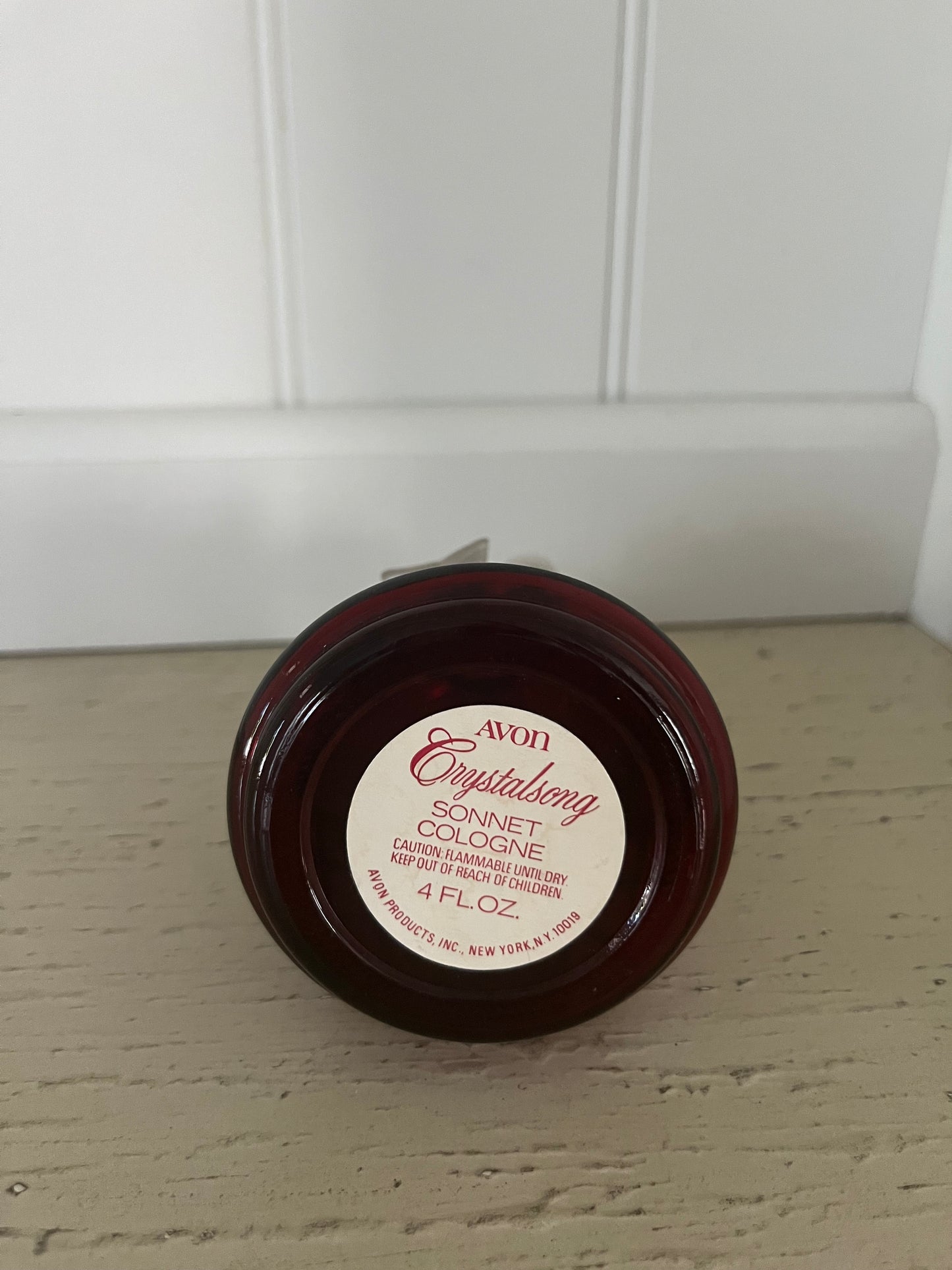 1970s vintage Avon Crystalsong Sonnet cologne Empty Ruby Red bottle in a bell shape with a clear  bow stopper