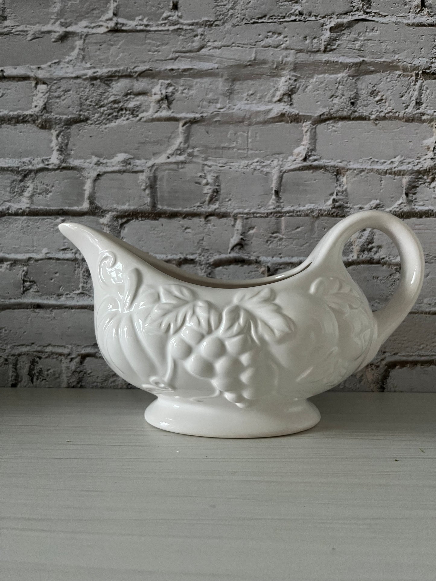 Tabletops Gallery “Harvest” White Ceramic Gravy Boat
Embossed Grapes & Leaves • Footed Autumn Serveware