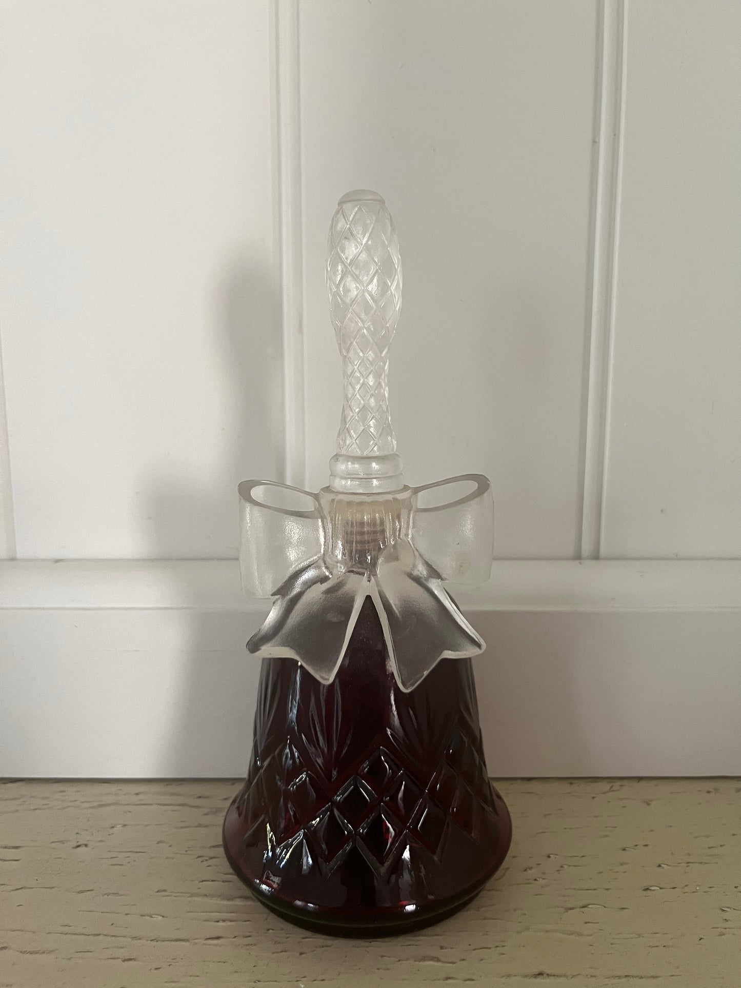 1970s vintage Avon Crystalsong Sonnet cologne Empty Ruby Red bottle in a bell shape with a clear  bow stopper