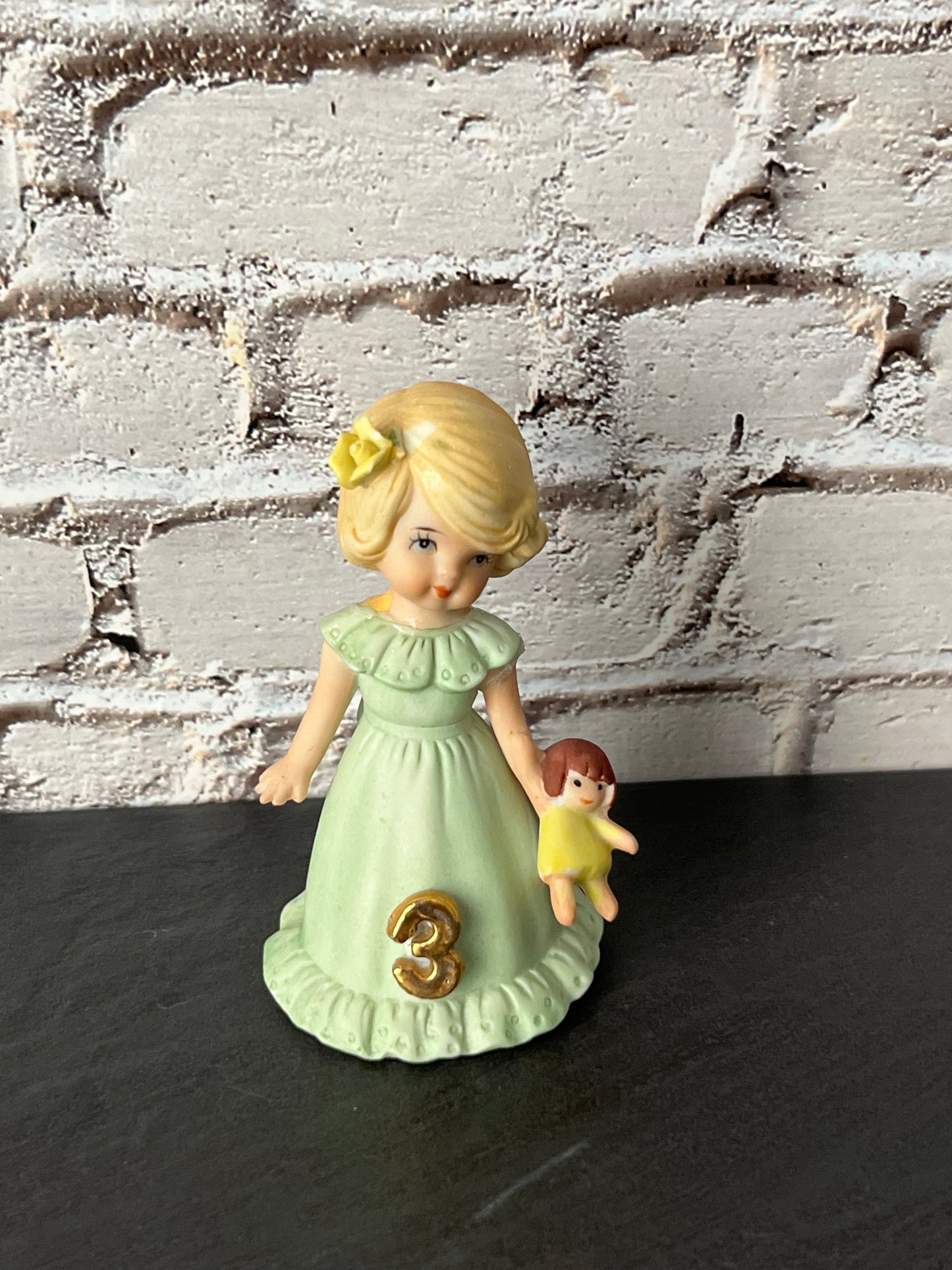 Vintage Enesco Growing Up Birthday Girls Age 3 Figurine – Bisque Porcelain Touched Up/Repaired Blonde Girl with Doll Pastel Green Dress (1980s–1990s)