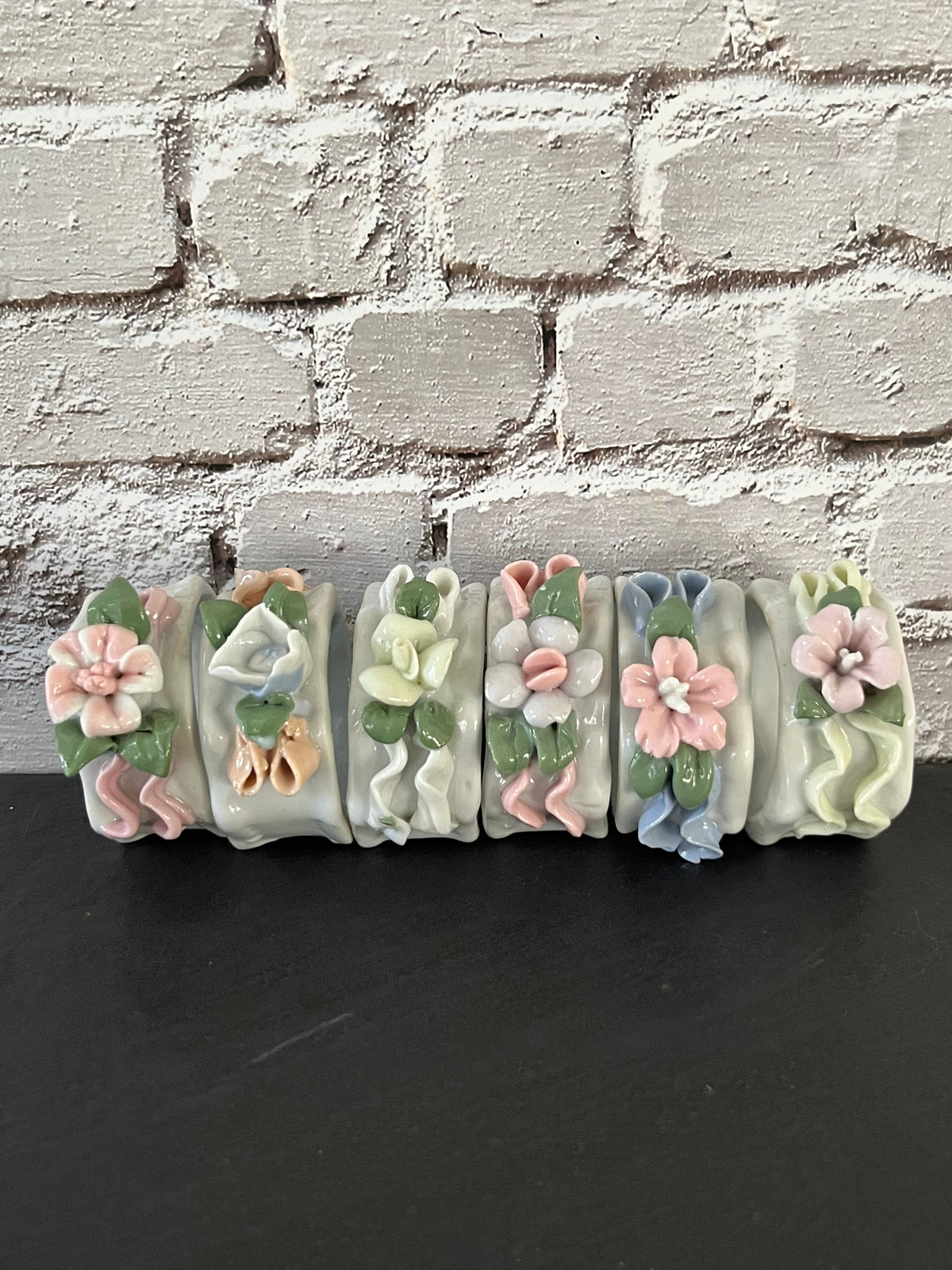 Vintage 1980s Glazed Porcelain Sculpted Floral Napkin Rings – Set of 6 Pastel 3D Flowers & Ribbons