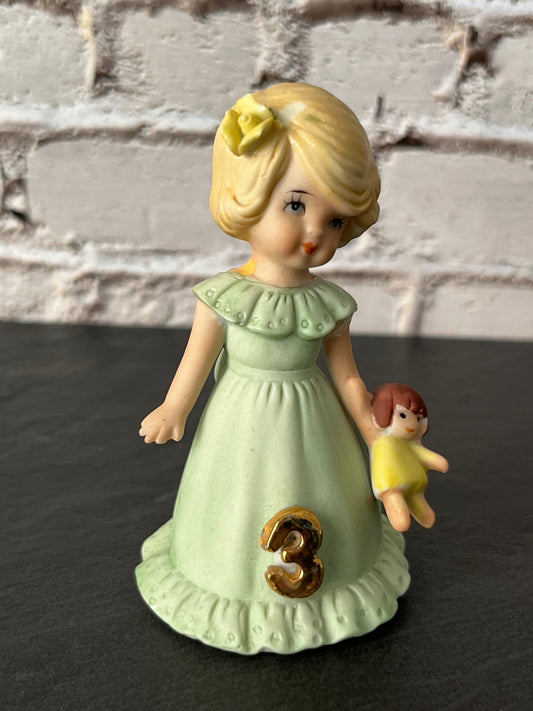 Vintage Enesco Growing Up Birthday Girls Age 3 Figurine – Bisque Porcelain Touched Up/Repaired Blonde Girl with Doll Pastel Green Dress (1980s–1990s)